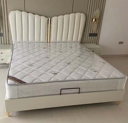 White Channel-Tufted Upholstered Platform Bed with Scalloped Headboard and Gold Accents