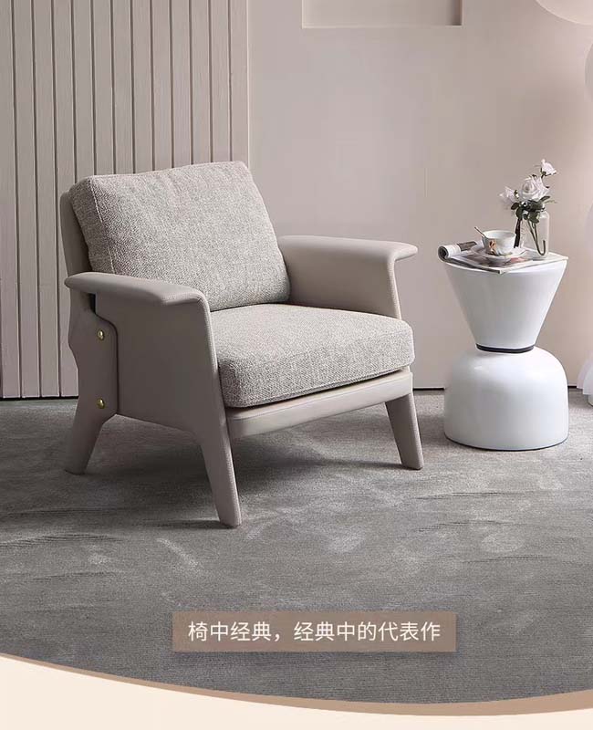 Light Gray Upholstered Accent Armchair with Padded Arms and Brass Side Fasteners