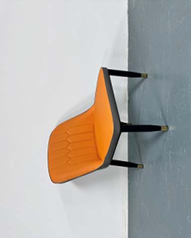 Armless Quilted Orange Upholstered Dining Chair with Black Metal Legs and Brass Foot Caps