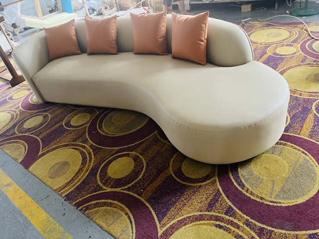 Curved Upholstered Four-Seat Lounge Sofa with Chaise End and Throw Pillows